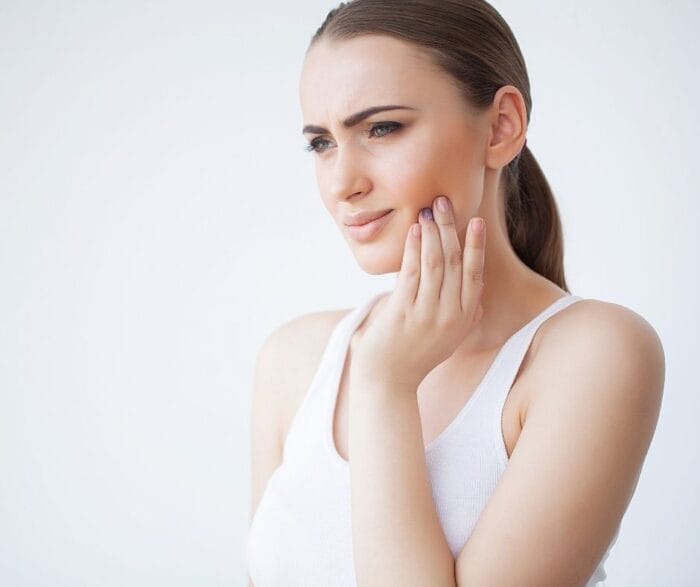 tmj headache pain | woman with jaw pain