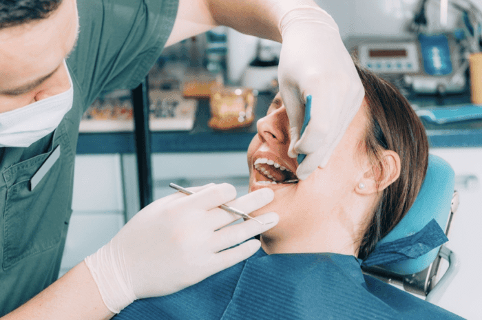 dentist checking patient's tooth