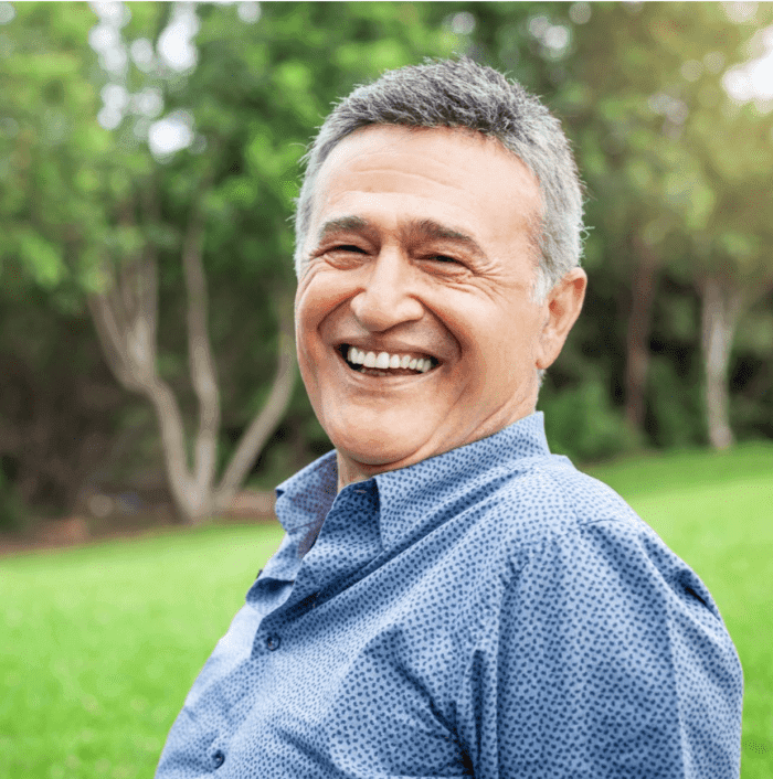 senior man smiling with dental implants