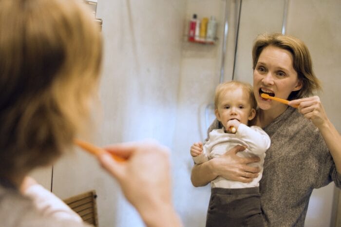 mom and child brushing teeth