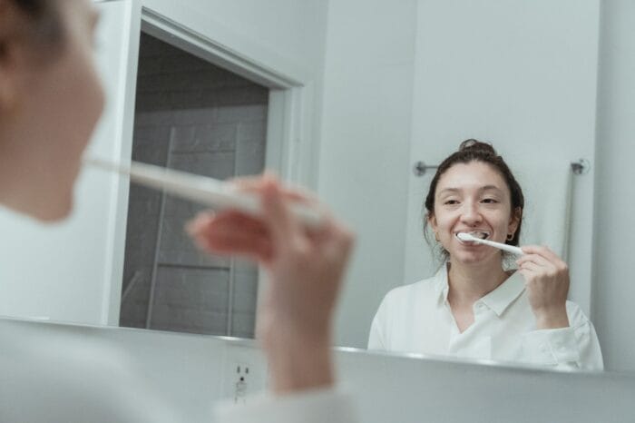 woman brushing teeth