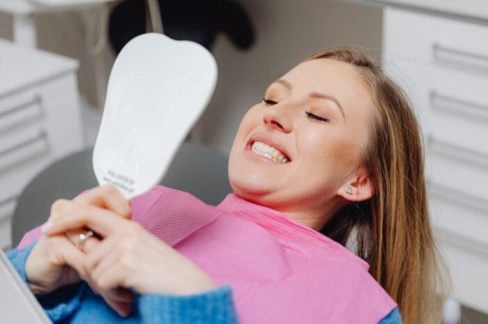 patient looking at teeth in the mirror