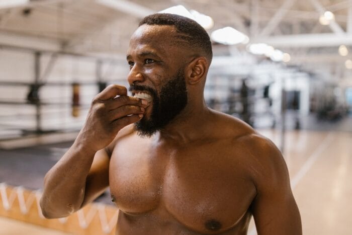 athlete putting on mouthguard