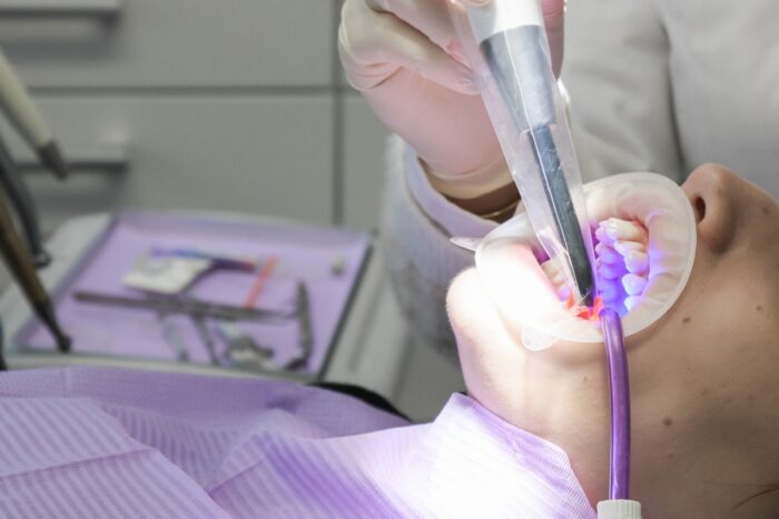Patient receiving a routine dental checkup during a six-month preventive visit