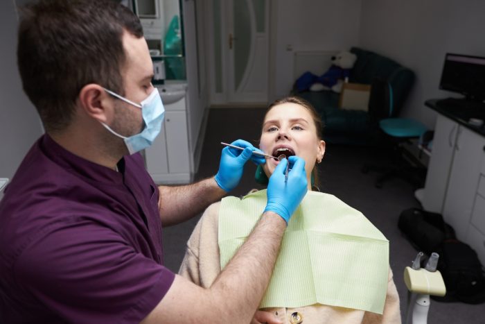 Dentist examining patient to repair cavities and restore function
